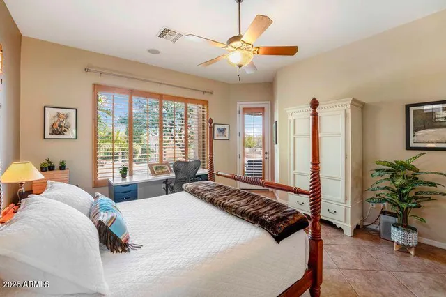 a bedroom with a bed and a potted plant