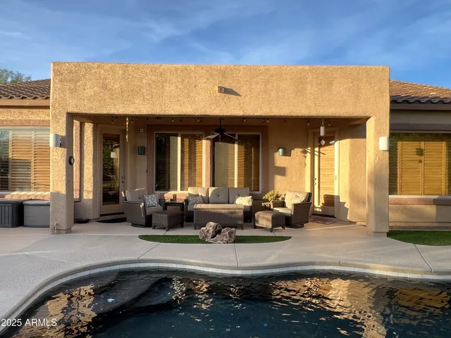 a living room with furniture a large window and a flat screen tv