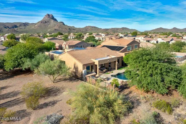 a kitchen with stainless steel appliances granite countertop a stove top oven a sink a dining table and chairs