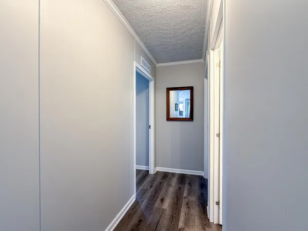 a bathroom with a granite countertop double vanity sink a mirror and a shower