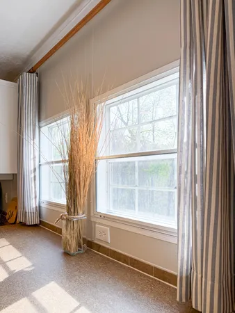 a room with pool table and windows