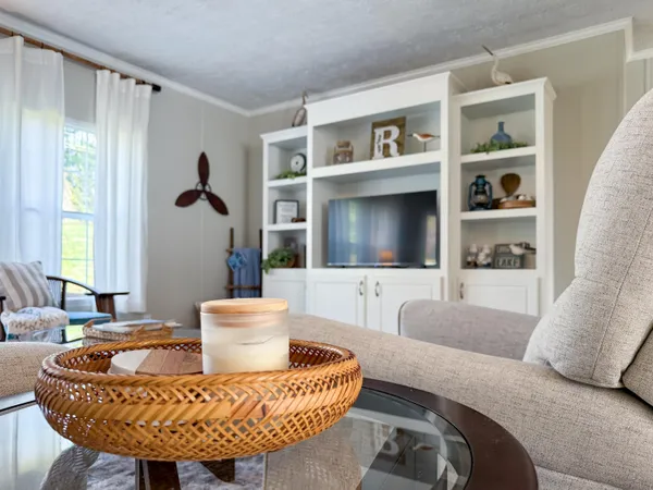 a living room with furniture and a flat screen tv