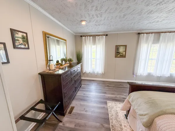 a spacious bathroom with a double vanity sink a mirror and a shower