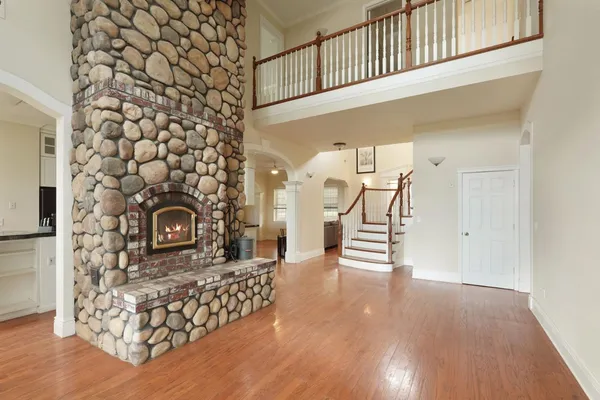 a view of an empty room with a fireplace and a window
