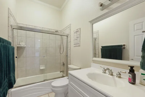 an empty room with windows and ceiling fan