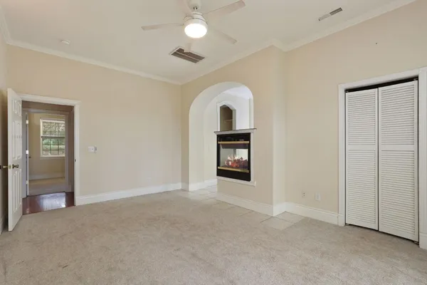 a view of a closet area with lots of white wooden cabinets