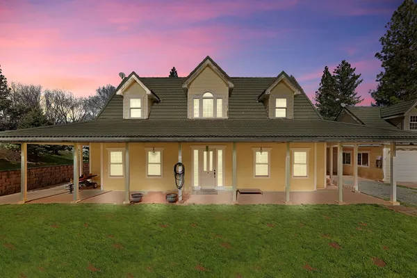 a front view of a house with a garden