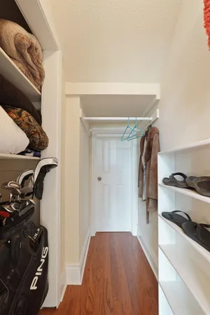 a view of a livingroom with a ceiling fan & windows