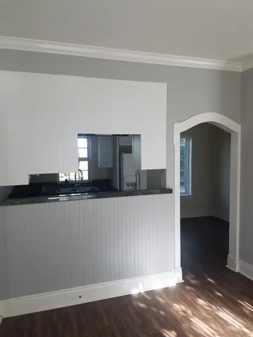 a view of a living room with wooden floor and staircase