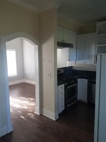 a kitchen with granite countertop a stove and a refrigerator