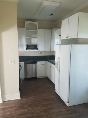 a kitchen with cabinets and white appliances