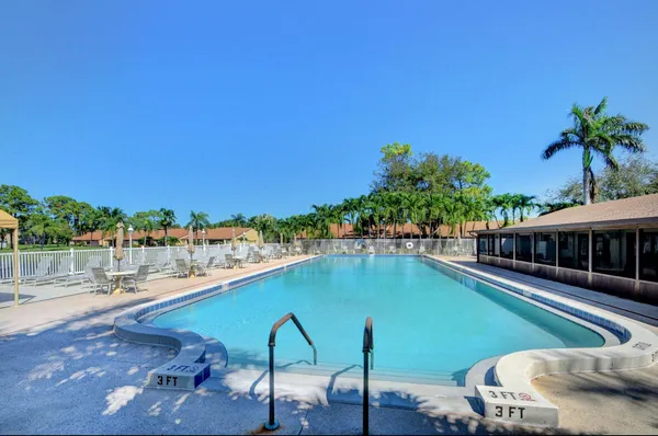 a view of a swimming pool with an outdoor seating