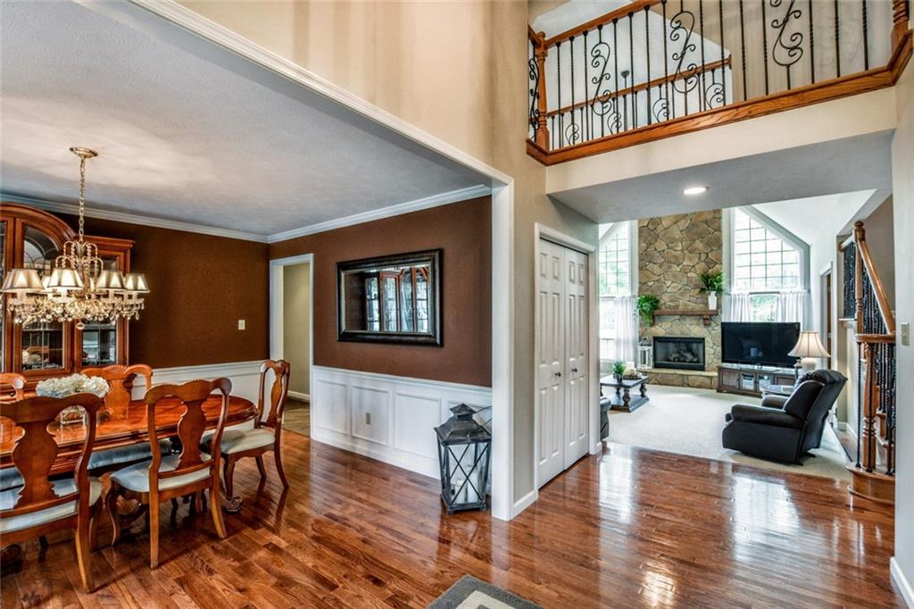 322 Stoup Road Mars, PA 16046 - Photo 12 of 25 a living room with furniture a dining table and a chandelier