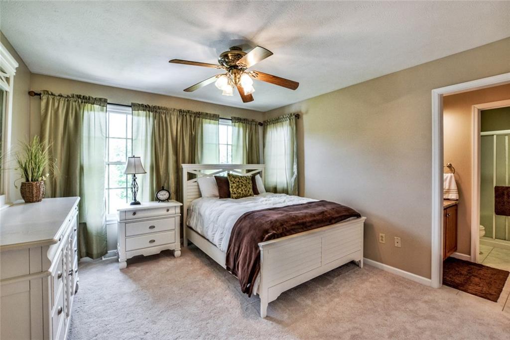 322 Stoup Road Mars, PA 16046 - Photo 19 of 25 a spacious bedroom with a bed and a chandelier