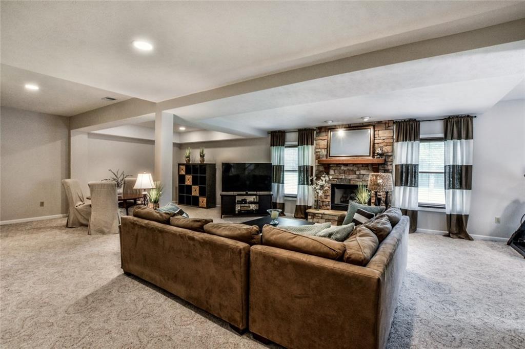 322 Stoup Road Mars, PA 16046 - Photo 22 of 25 a living room with furniture a fireplace and a flat screen tv