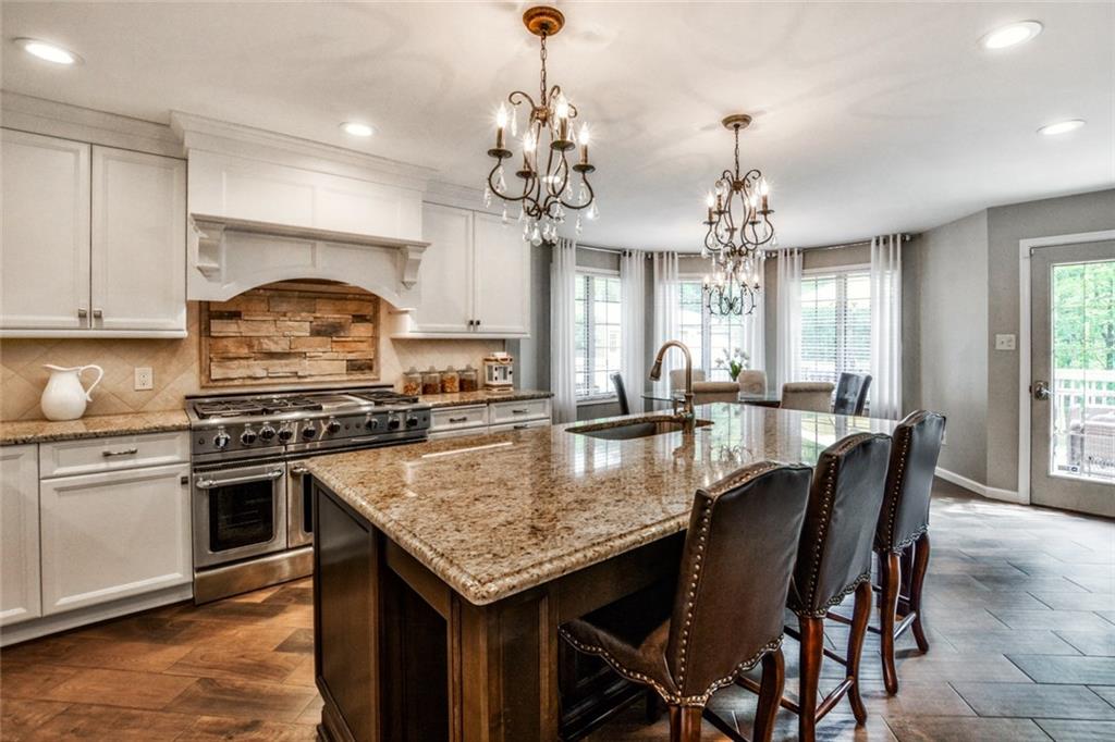 322 Stoup Road Mars, PA 16046 - Photo 4 of 25 a kitchen with stainless steel appliances granite countertop a kitchen island a stove a table and chairs in it