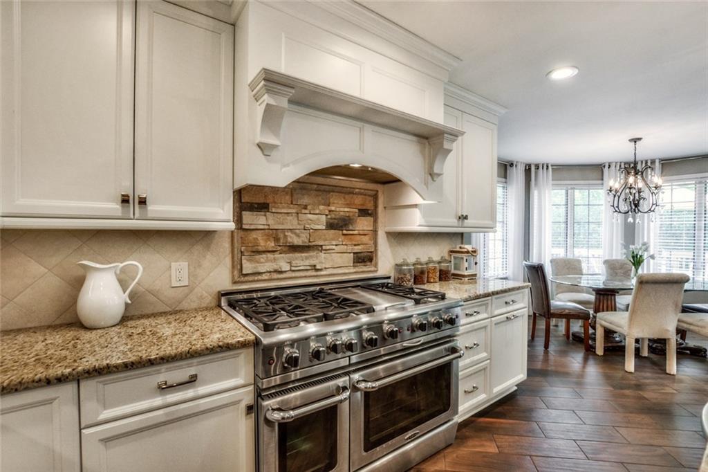 322 Stoup Road Mars, PA 16046 - Photo 5 of 25 a kitchen with granite countertop a stove and a wooden floors