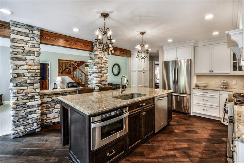 322 Stoup Road Mars, PA 16046 - Photo 7 of 25 a kitchen with stainless steel appliances granite countertop a stove and a refrigerator