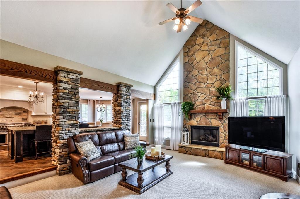 322 Stoup Road Mars, PA 16046 - Photo 8 of 25 a living room with furniture a fireplace and a flat screen tv