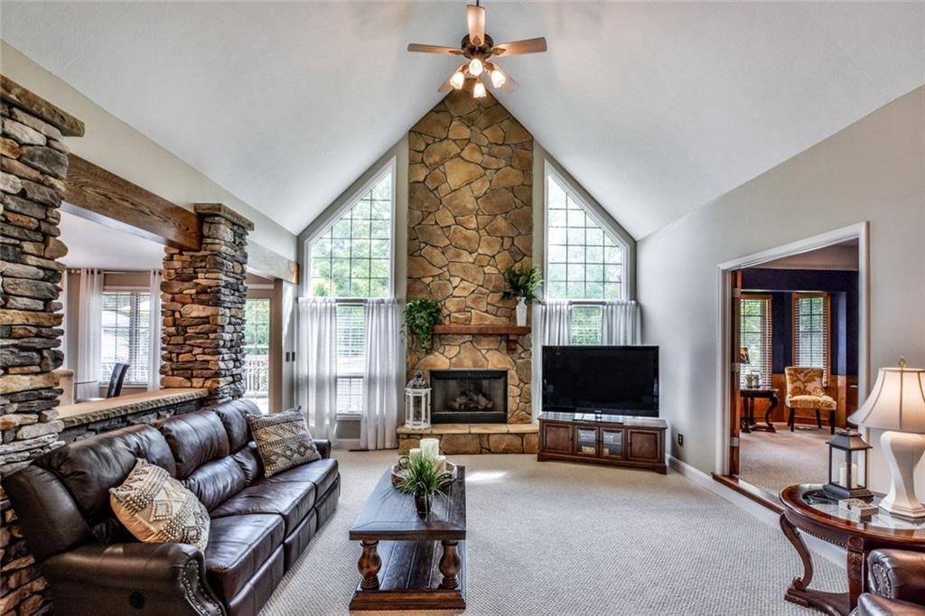 322 Stoup Road Mars, PA 16046 - Photo 9 of 25 a living room with furniture a flat screen tv and a fireplace