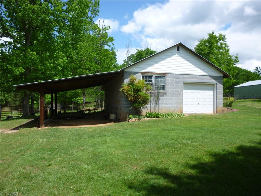 1476 Barker Road Roaring River, NC 28669 - Photo 18 of 29 (Shop #2) with attached shelter, garage door and walk in door on side. Measures 32.9 X 27.5 without shelter.