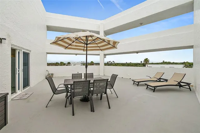 a view of a dining room with furniture and window