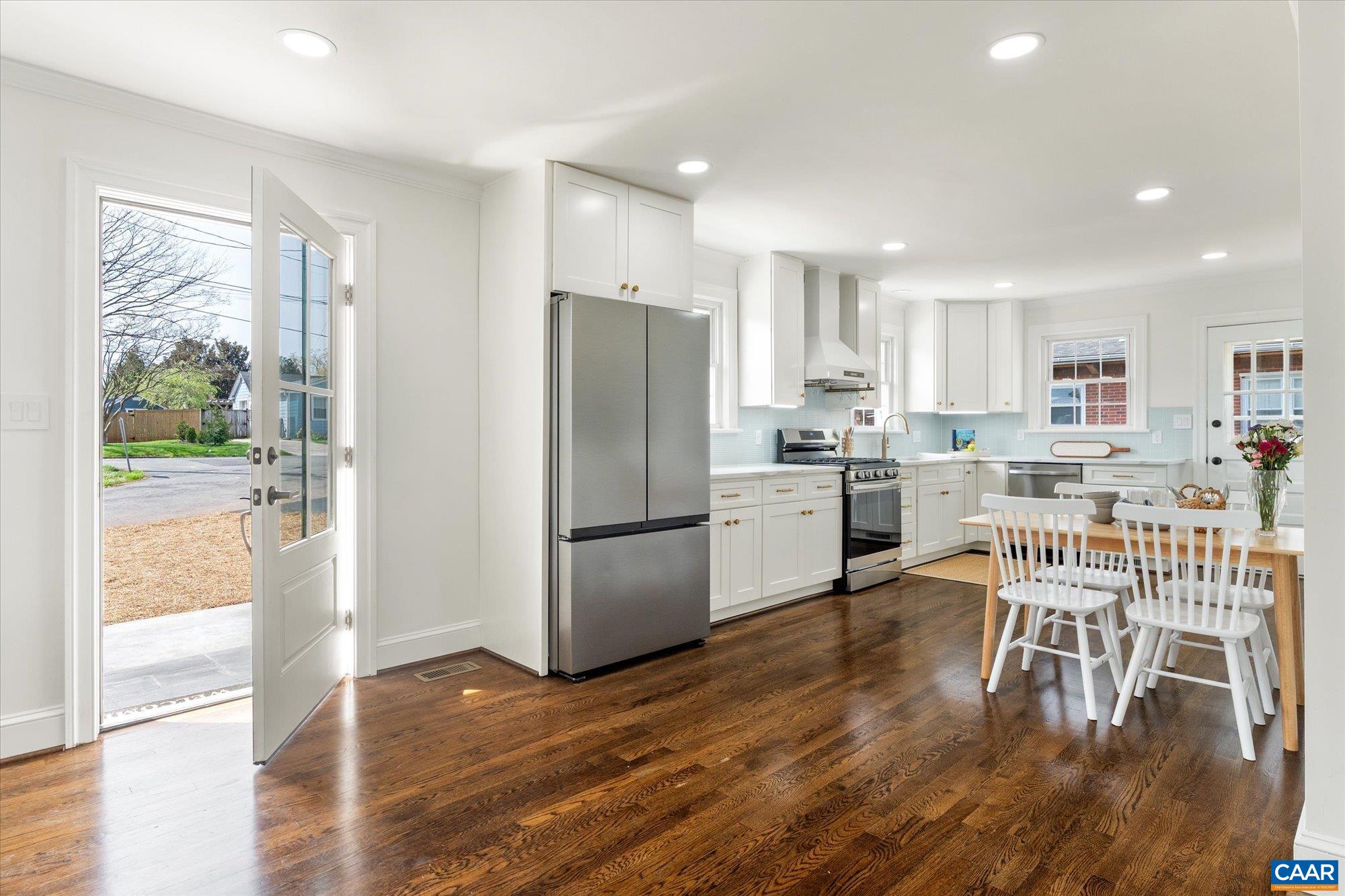 1449 Rutledge Avenue Charlottesville, VA 22903 - Photo 12 of 46 a kitchen with a refrigerator a dining table and chairs