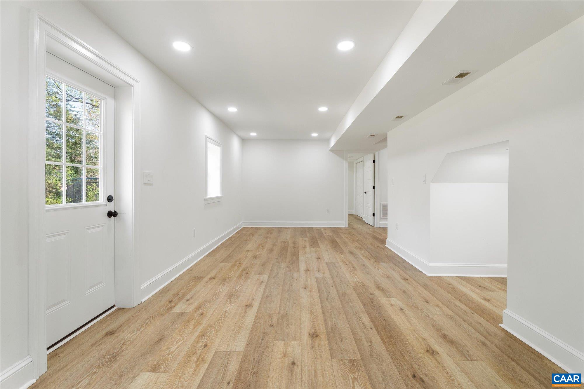 1449 Rutledge Avenue Charlottesville, VA 22903 - Photo 32 of 46 an empty room with wooden floor and windows