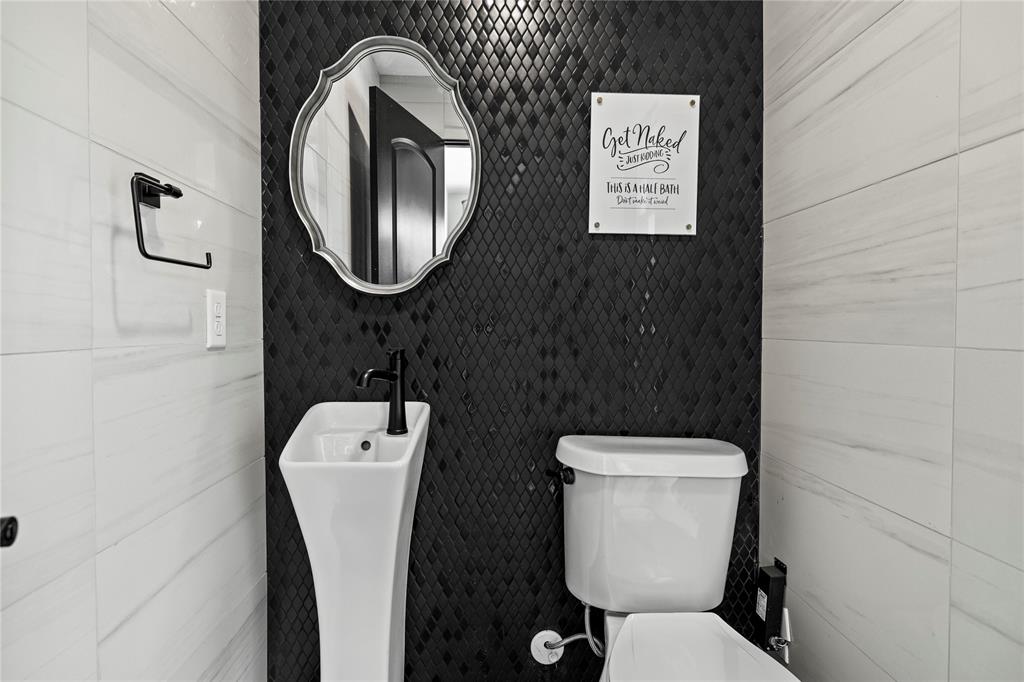 1300 Montclair Street Longview, TX 75601 - Photo 23 of 39 Bathroom featuring toilet and tile walls