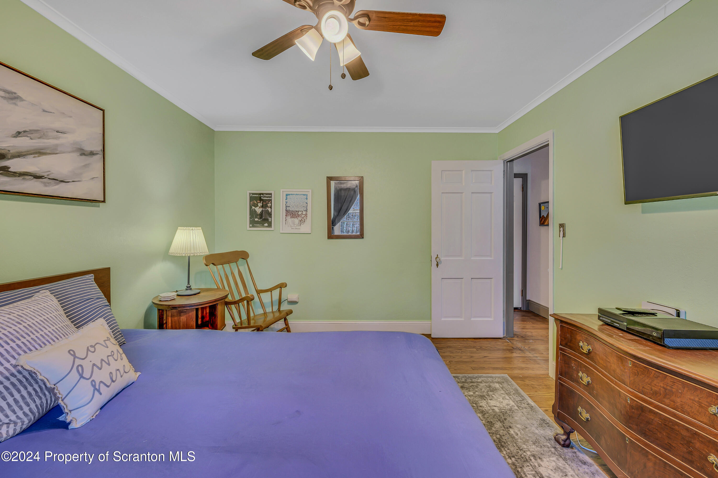 215 Maple Lake Road Moscow, PA 18444 - Photo 23 of 46 a bedroom with a bed and a chandelier