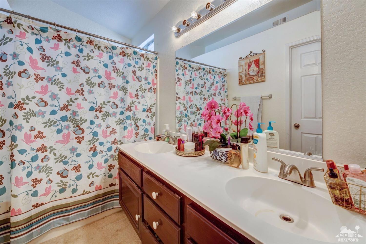 83948 Pacifica Sur Indio, CA 92203 - Photo 11 of 16 a bathroom with a sink mirror and vanity
