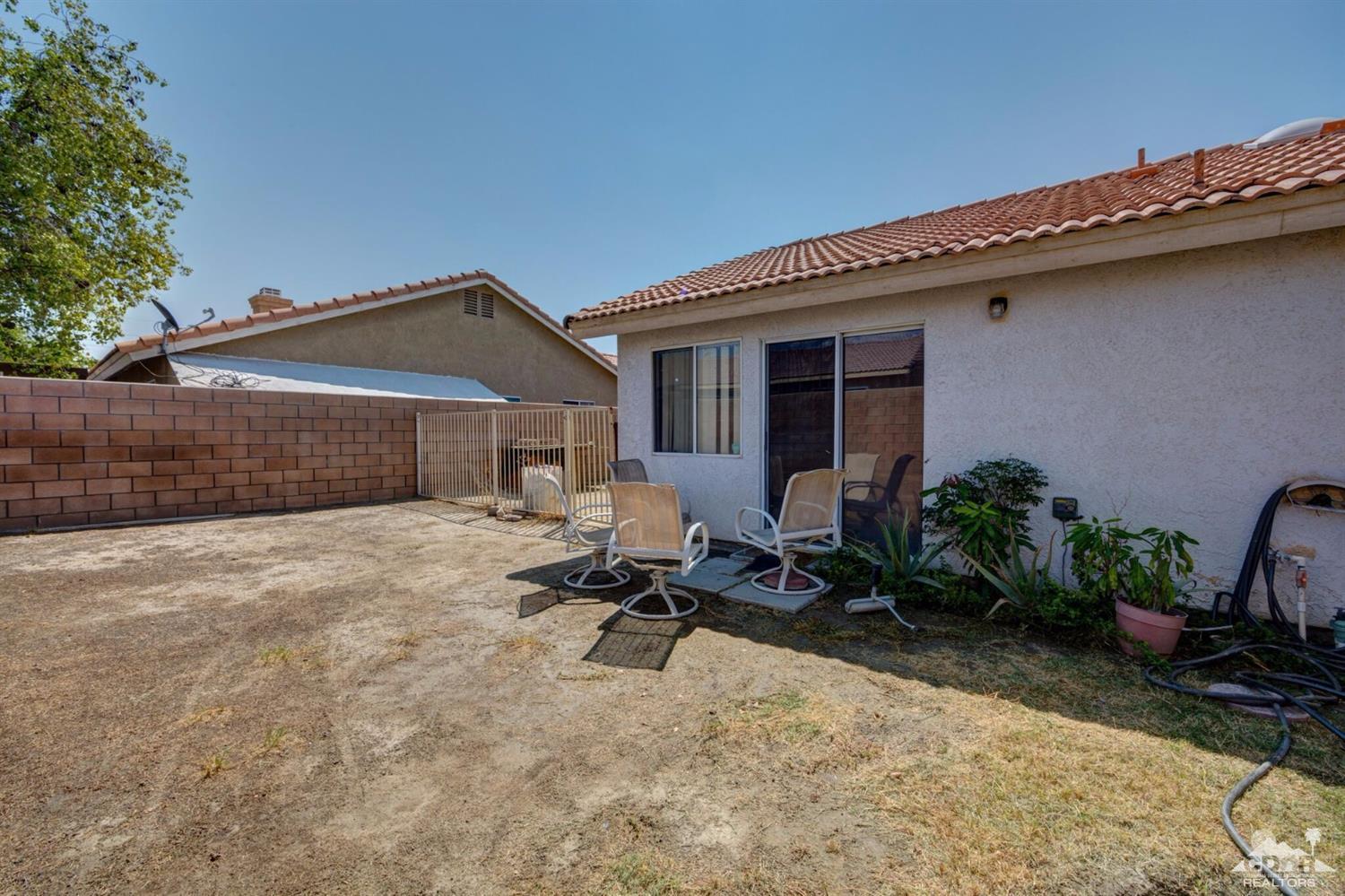 83948 Pacifica Sur Indio, CA 92203 - Photo 15 of 16 a backyard of a house with seating space