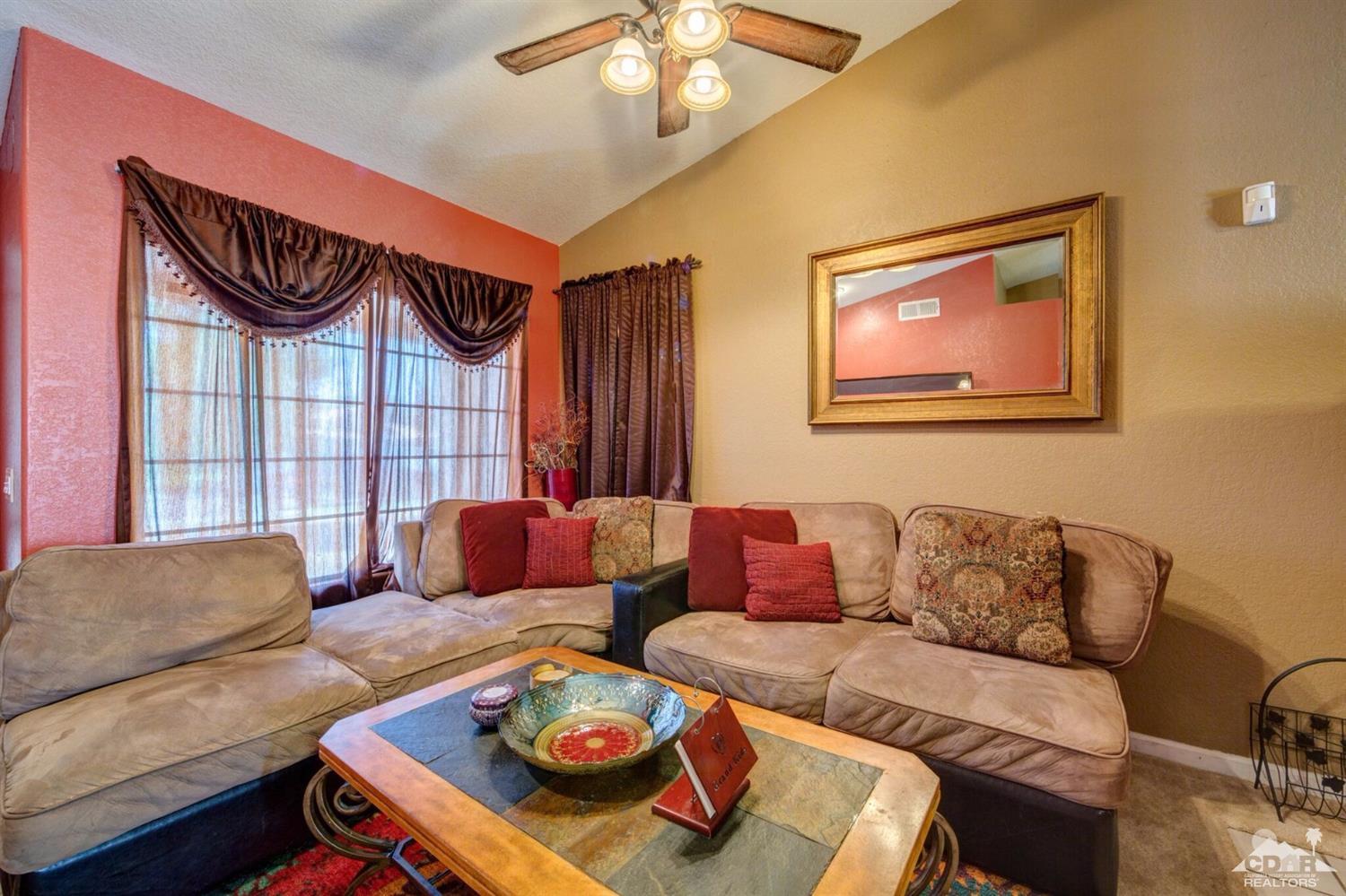83948 Pacifica Sur Indio, CA 92203 - Photo 6 of 16 a living room with furniture and a large window