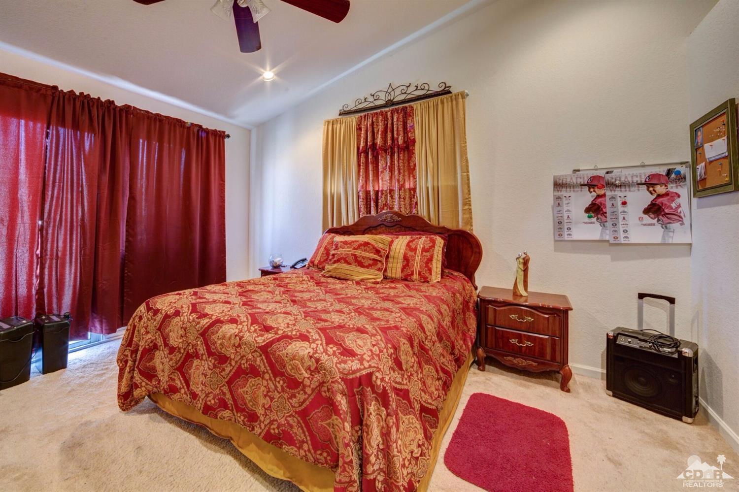 83948 Pacifica Sur Indio, CA 92203 - Photo 8 of 16 a bedroom with a bed dresser and a window