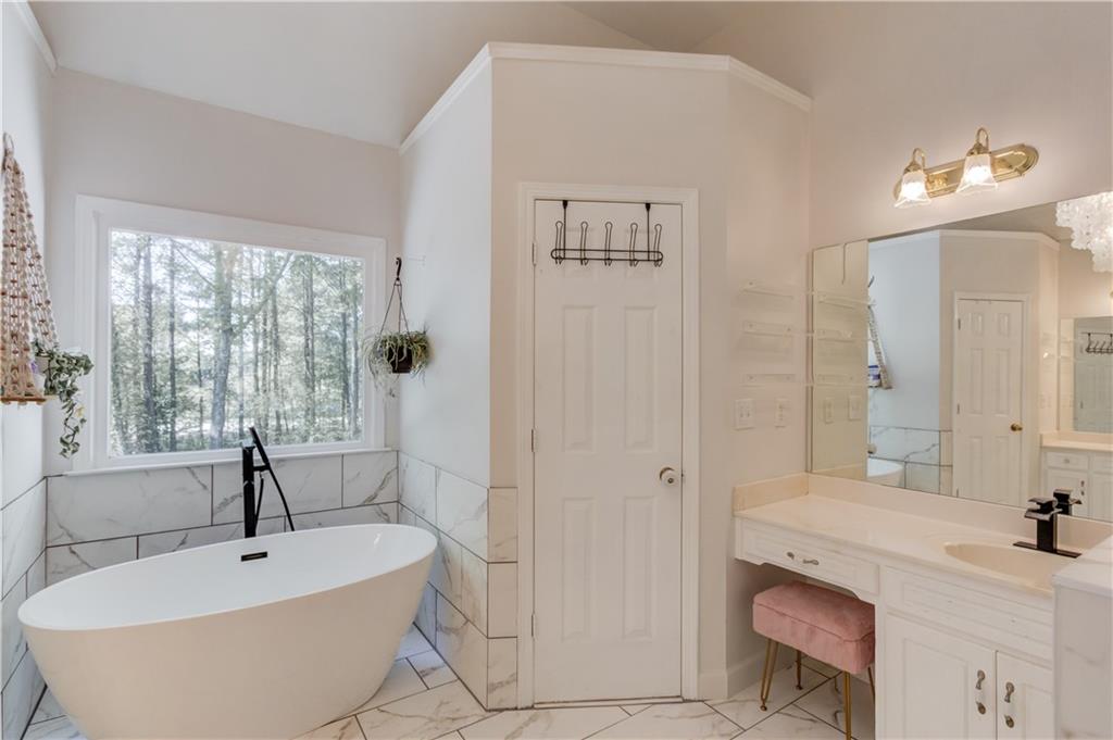 2310 Olde Hickory Place Monroe, GA 30656 - Photo 20 of 46 a bathroom with a bathtub sink and mirror