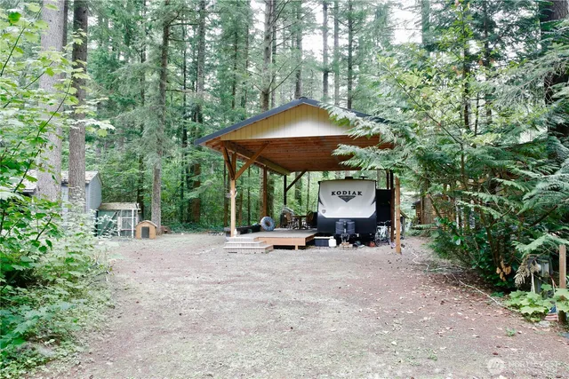 a view of a table and chairs under an umbrella