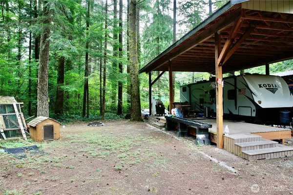a view of a patio with table and chairs under an umbrella