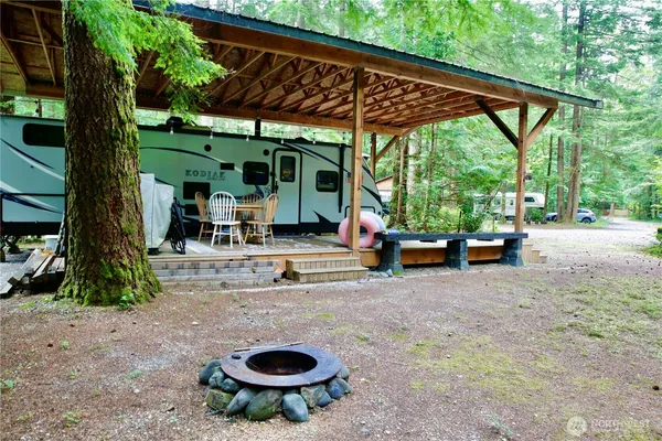 a view of a backyard with table and chairs under an umbrella