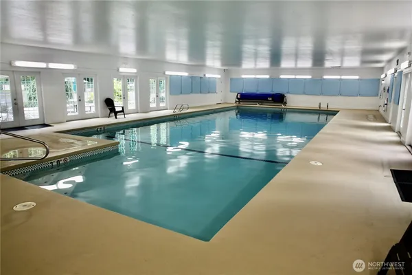 a view of a swimming pool with outdoor seating