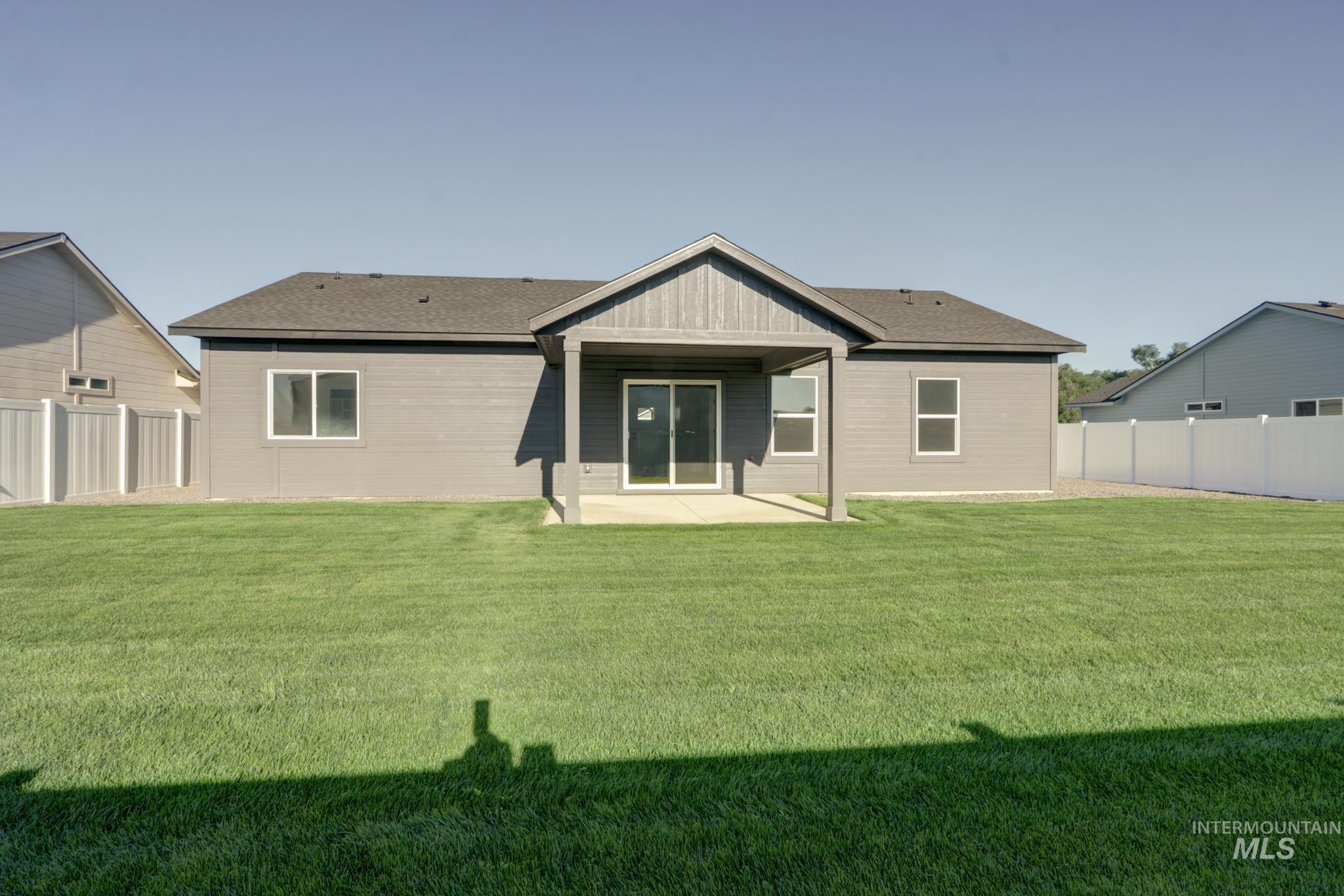 848 North 5th Street Nyssa, OR 97913 - Photo 47 of 49 Expansive rear yard featuring a covered patio, sliding glass door entry, and multiple windows