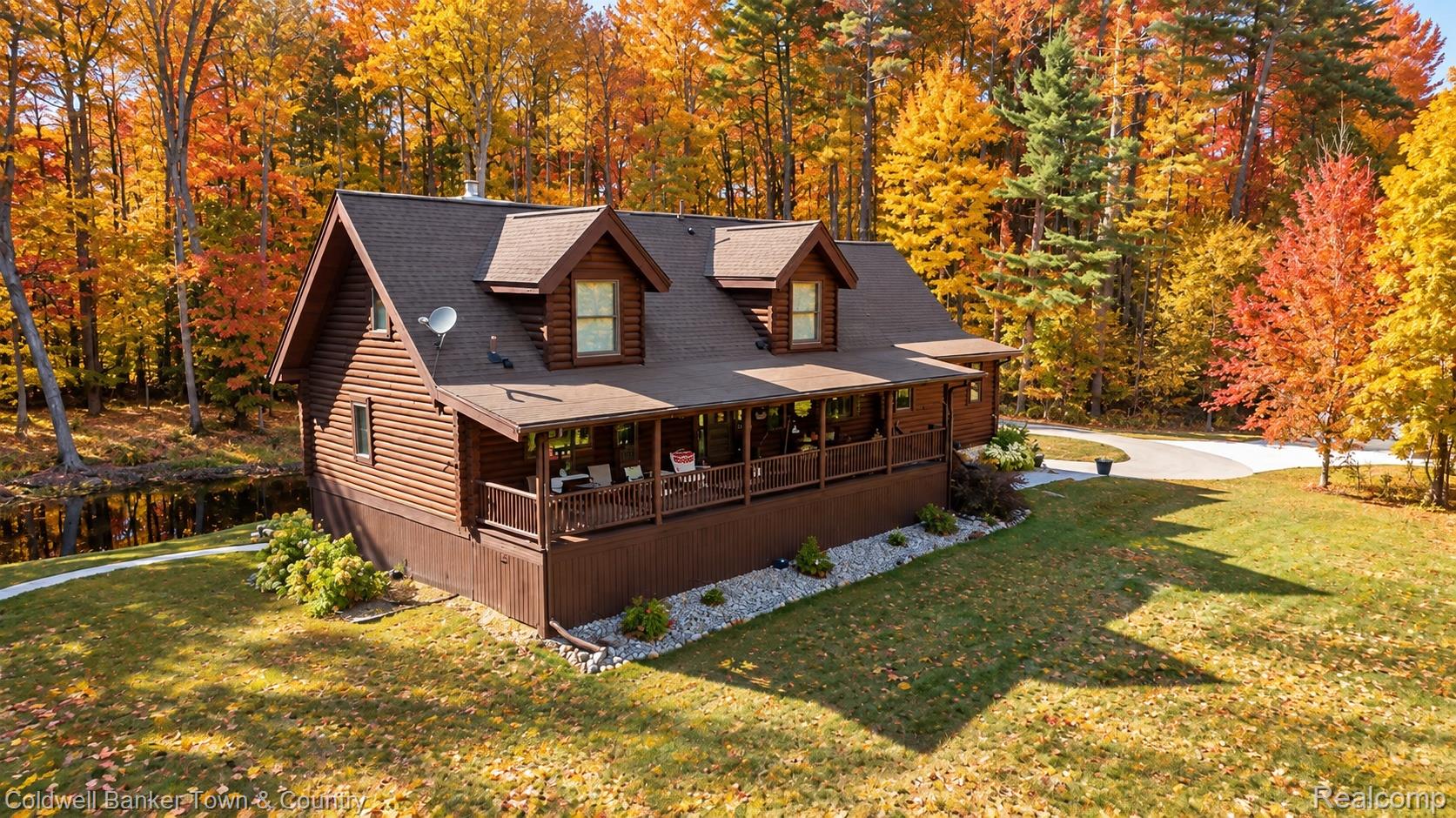 7023 Munsell Road Howell, MI 48843 - Photo 1 of 55 Wood-sided residence with multiple dormers and a covered porch