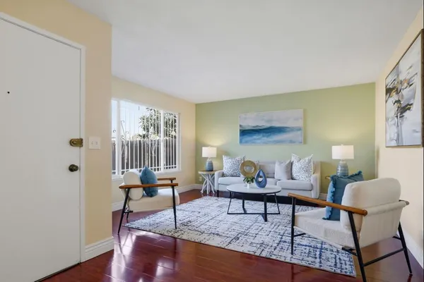 a living room with furniture and a potted plant