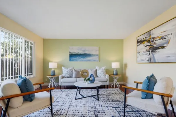 a living room with furniture and wooden floor