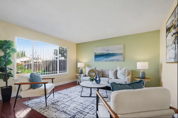 a living room with furniture and a potted plant