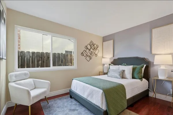a bedroom with a bed and a chair