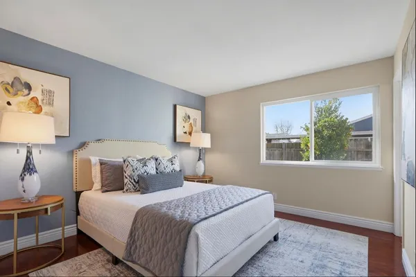 a bedroom with a bed and a window