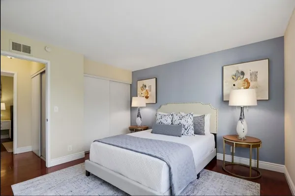a bedroom with a bed and a lamp on table