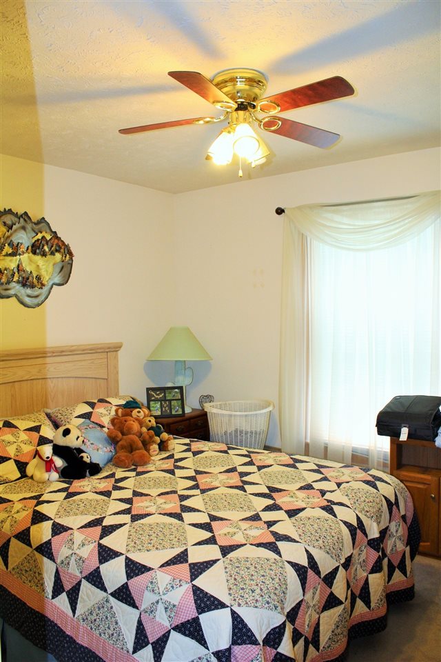 17 Deer Path Road Palmyra, VA 22963 - Photo 8 of 10 a bedroom with a bed and a chandelier