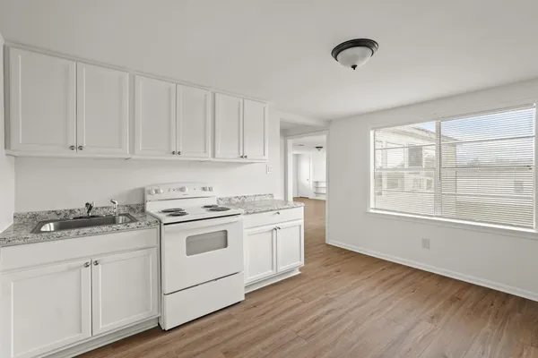 a view of a kitchen with sink and cabinets