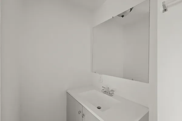 a bathroom with a sink and mirror